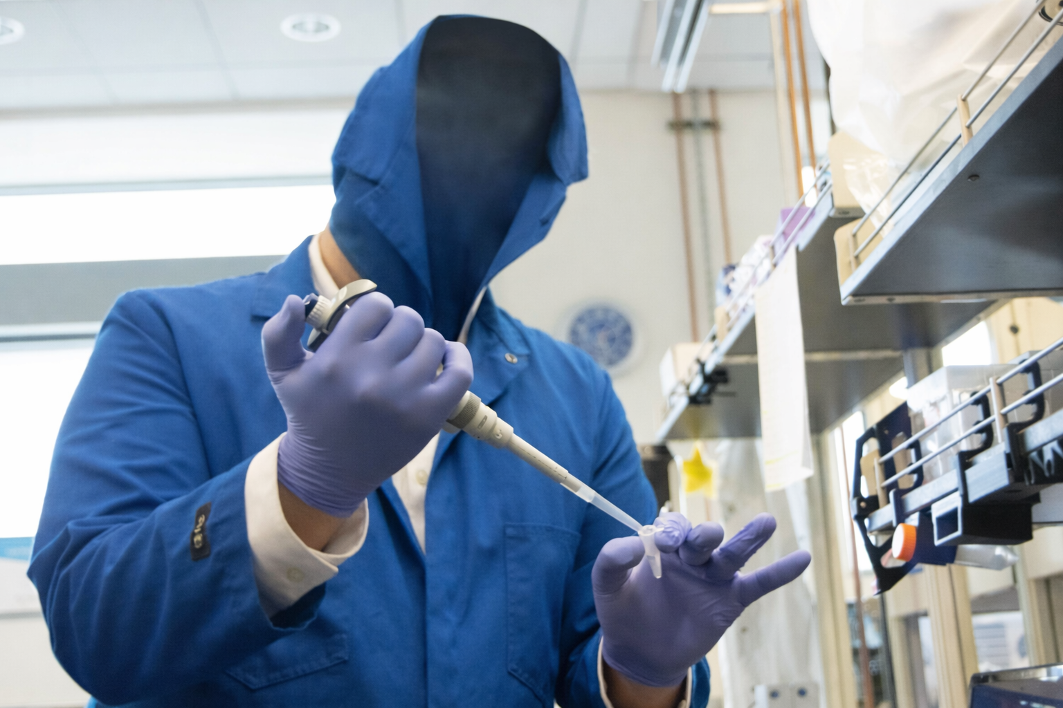 researcher preparing liquid in lab