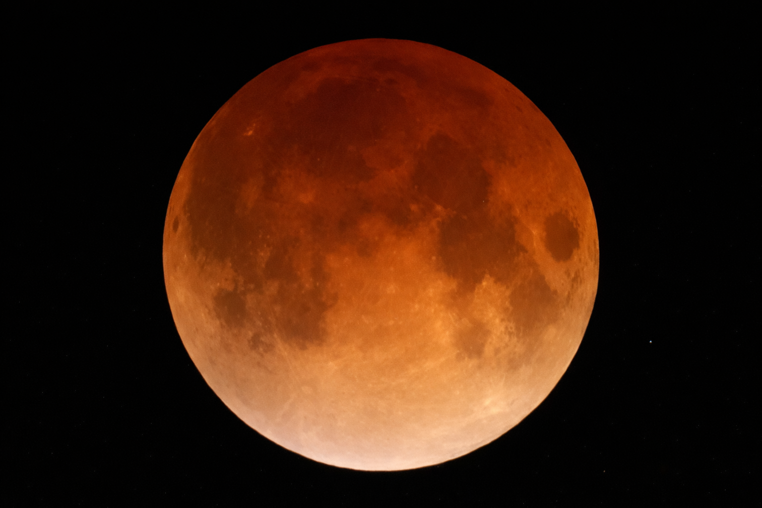 blood moon eclipse against starry sky