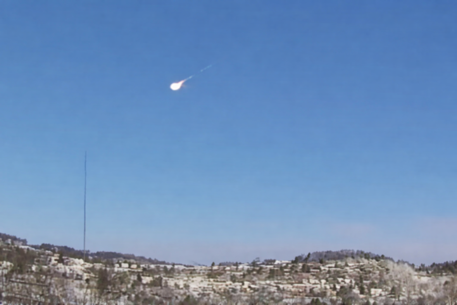 fireball streaks across snowy hills