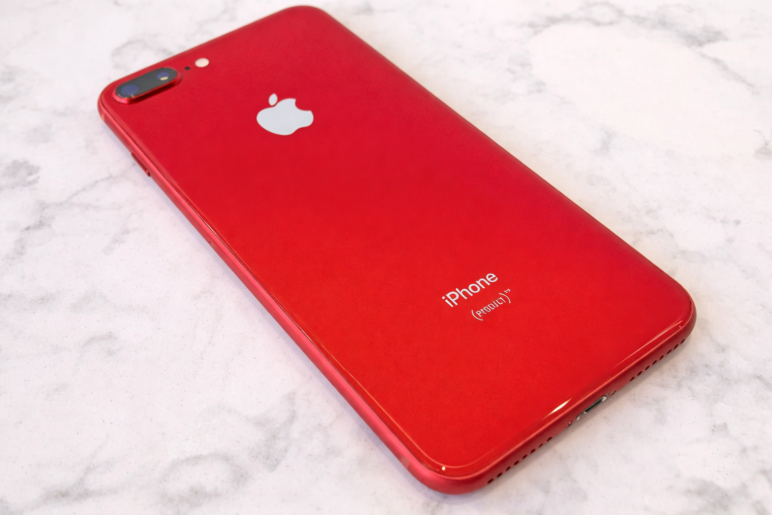 red iphone on marble surface