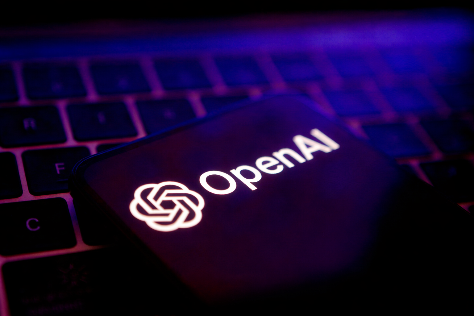 glowing openai logo on keyboard
